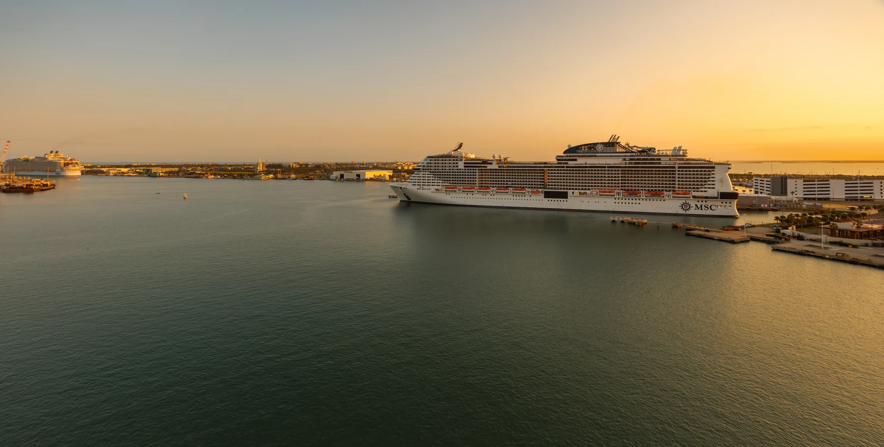 Cruise ships at Port Canaveral as the sun sets over the water