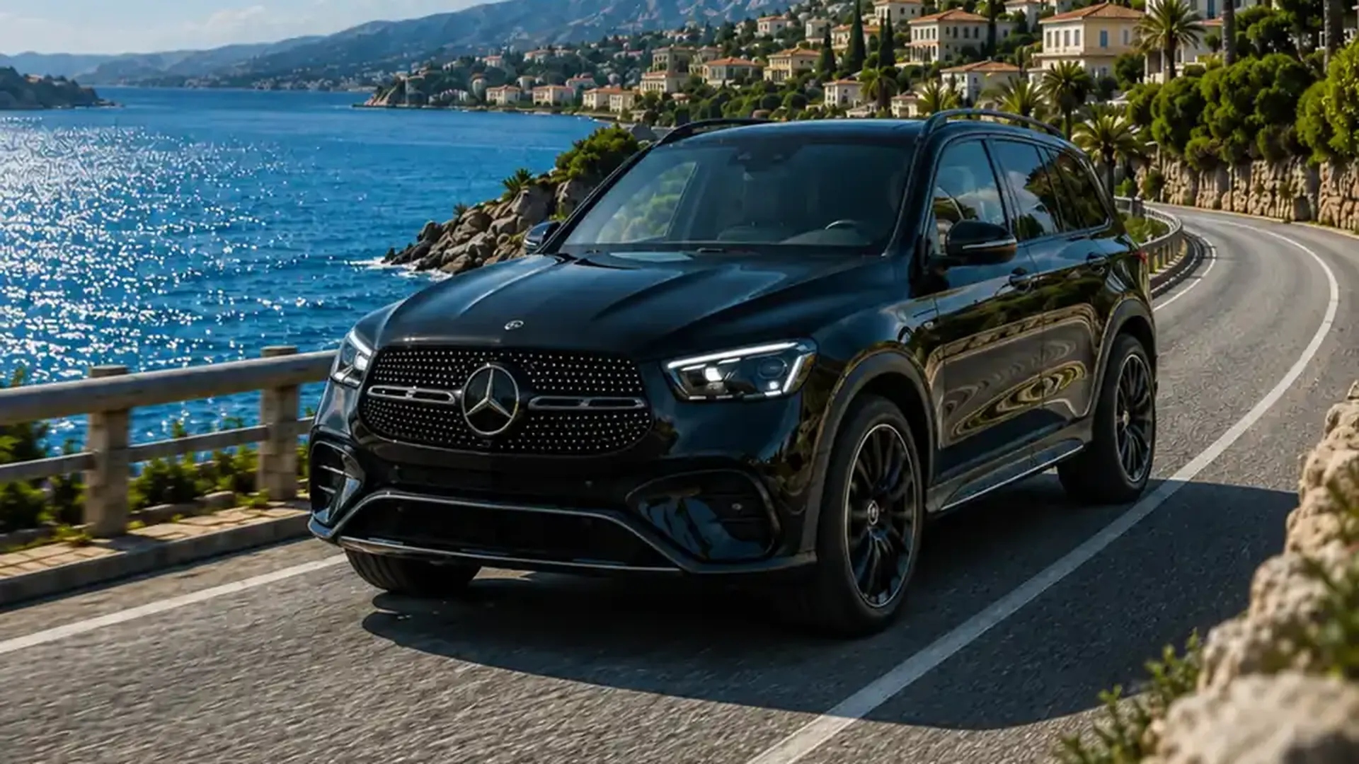 Black executive SUV on a coastal road overlooking the sea